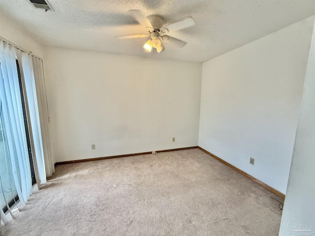 unfurnished room featuring light carpet, a textured ceiling, and ceiling fan