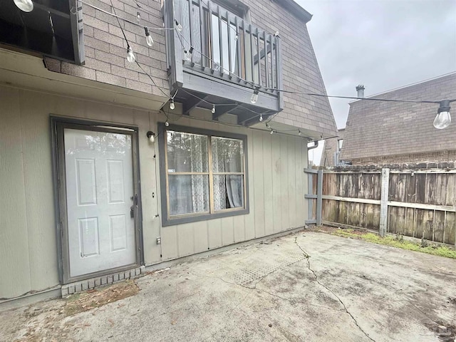 entrance to property with a balcony and a patio area