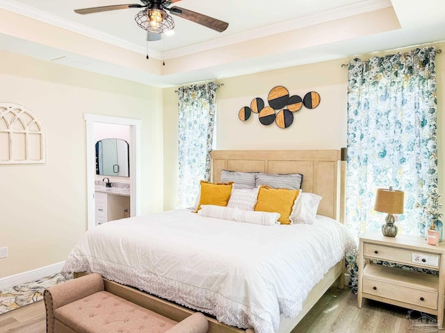 bedroom featuring a raised ceiling, crown molding, and hardwood / wood-style floors