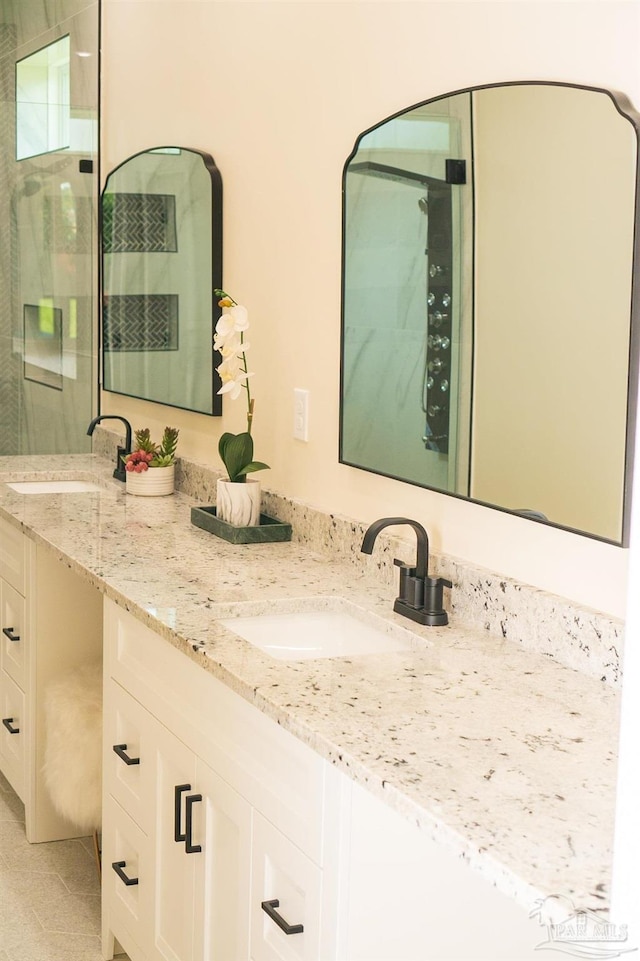 bathroom featuring walk in shower, tile patterned floors, and vanity