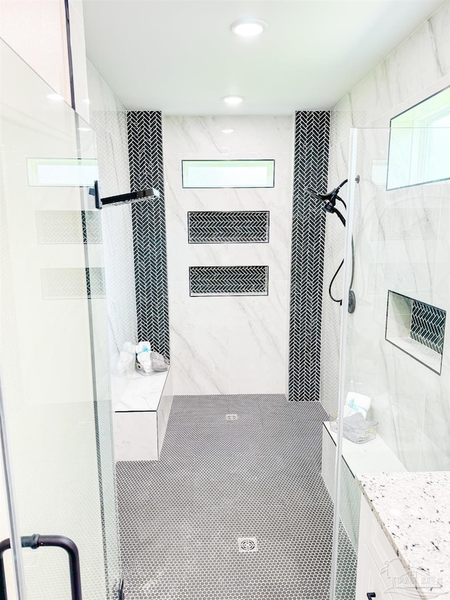 bathroom featuring a healthy amount of sunlight and an enclosed shower