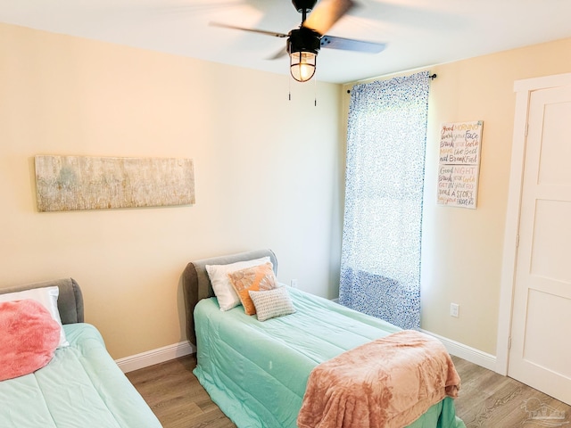 bedroom with ceiling fan and light hardwood / wood-style floors