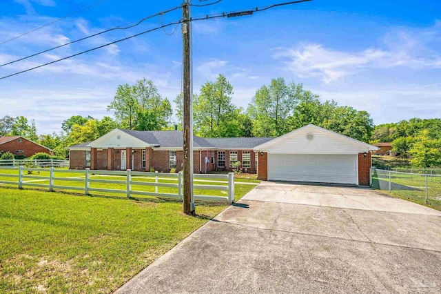 ranch-style house featuring a fenced front yard, a front lawn, brick siding, an attached garage, and driveway