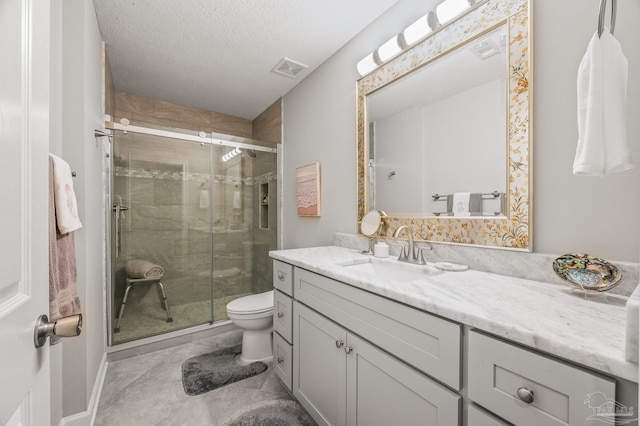 bathroom featuring visible vents, toilet, a shower stall, and vanity