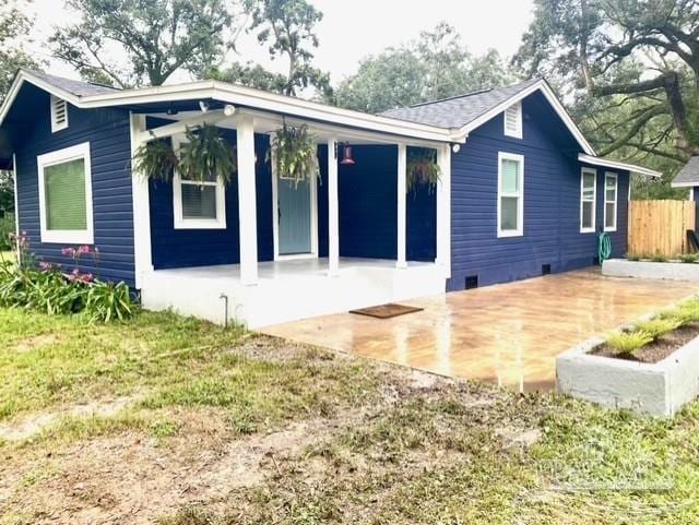 back of house with crawl space, fence, and a patio