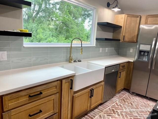 kitchen with stainless steel appliances, a sink, a wealth of natural light, decorative backsplash, and open shelves