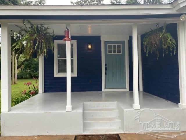 doorway to property featuring covered porch