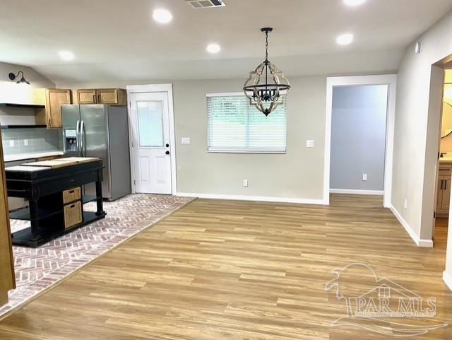 kitchen featuring tasteful backsplash, recessed lighting, stainless steel refrigerator with ice dispenser, and light wood finished floors