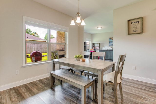 431 Broadleaf Cir, Cantonment, FL 32533 - dining room with a chandelier, baseboards, and wood finished floors