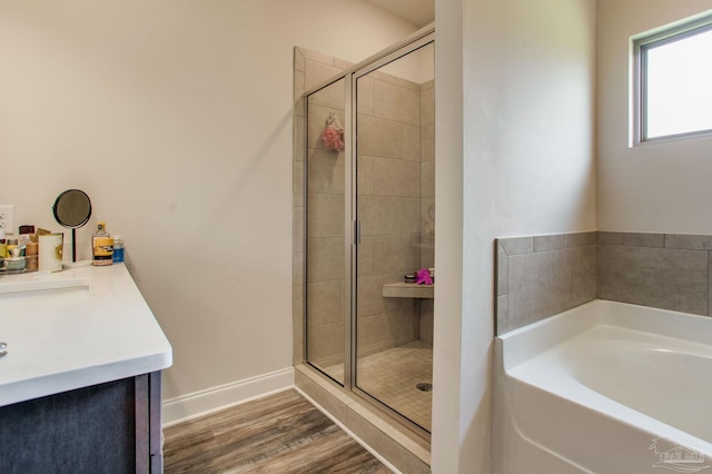 431 Broadleaf Cir, Cantonment, FL 32533 - bathroom with a garden tub, a stall shower, wood finished floors, and vanity