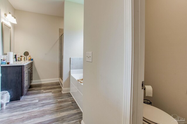 431 Broadleaf Cir, Cantonment, FL 32533 - full bathroom featuring vanity, wood finished floors, a bath, a stall shower, and toilet