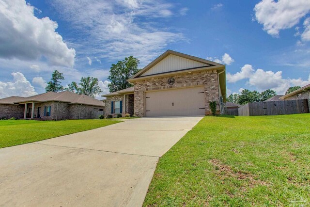 431 Broadleaf Cir, Cantonment, FL 32533 - ranch-style home featuring brick siding, concrete driveway, and an attached garage