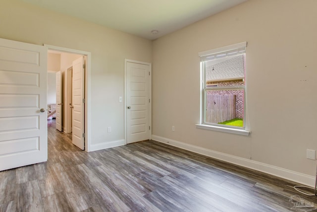 431 Broadleaf Cir, Cantonment, FL 32533 - unfurnished bedroom featuring wood finished floors and baseboards