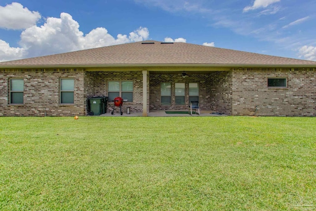 431 Broadleaf Cir, Cantonment, FL 32533 - back of house with a ceiling fan, a patio area, brick siding, a lawn, and roof with shingles