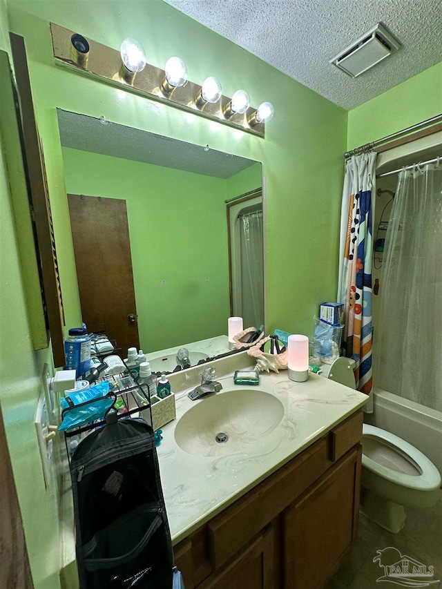 full bathroom featuring vanity, toilet, a textured ceiling, and shower / tub combo