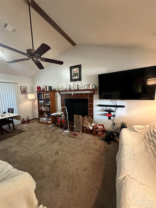 carpeted living room featuring lofted ceiling with beams, a fireplace, and ceiling fan