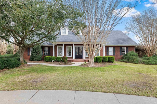 1788 Lorain Cir, Cantonment, FL 32533 - cape cod-style house featuring a front lawn, brick siding, a porch, and a shingled roof