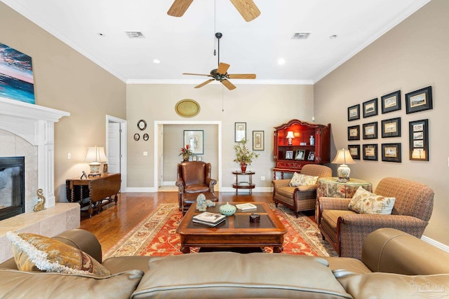 1788 Lorain Cir, Cantonment, FL 32533 - living area featuring a ceiling fan, wood finished floors, ornamental molding, a tiled fireplace, and baseboards
