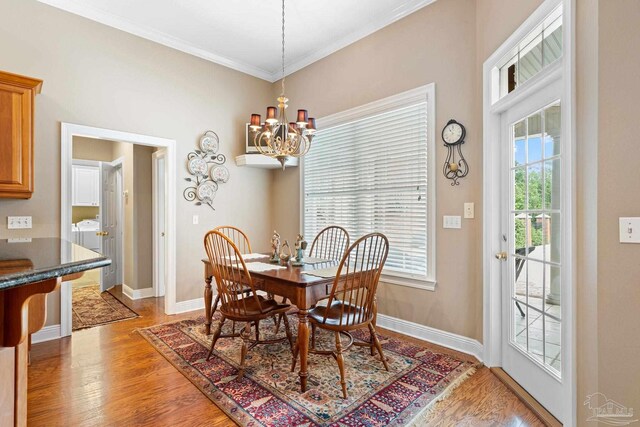 1788 Lorain Cir, Cantonment, FL 32533 - dining area with a chandelier, light wood finished floors, baseboards, and crown molding