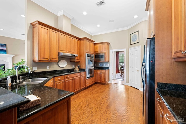 1788 Lorain Cir, Cantonment, FL 32533 - kitchen featuring a sink, stainless steel appliances, ornamental molding, brown cabinetry, and under cabinet range hood