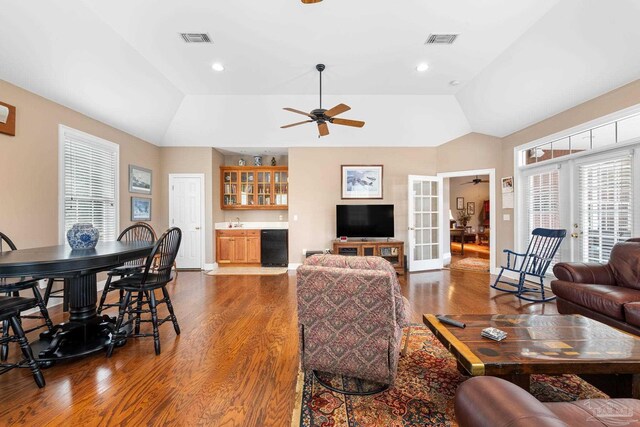 1788 Lorain Cir, Cantonment, FL 32533 - living area with wood finished floors, bar with sink, ceiling fan, vaulted ceiling, and baseboards