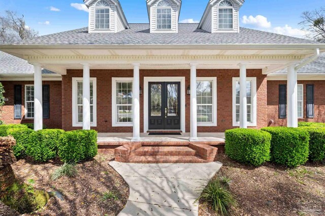 1788 Lorain Cir, Cantonment, FL 32533 - view of exterior entry featuring a porch, a shingled roof, french doors, and brick siding