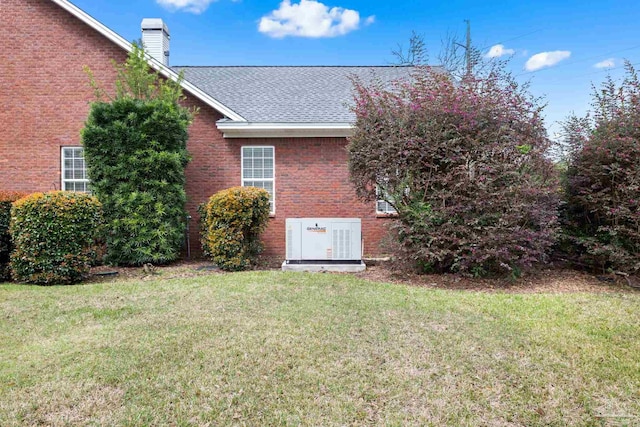 1788 Lorain Cir, Cantonment, FL 32533 - view of side of home with a chimney, brick siding, a yard, and a shingled roof