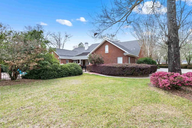 1788 Lorain Cir, Cantonment, FL 32533 - view of home's exterior featuring brick siding, a lawn, and a chimney