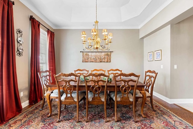 1788 Lorain Cir, Cantonment, FL 32533 - dining space with wood finished floors, a chandelier, baseboards, a raised ceiling, and crown molding