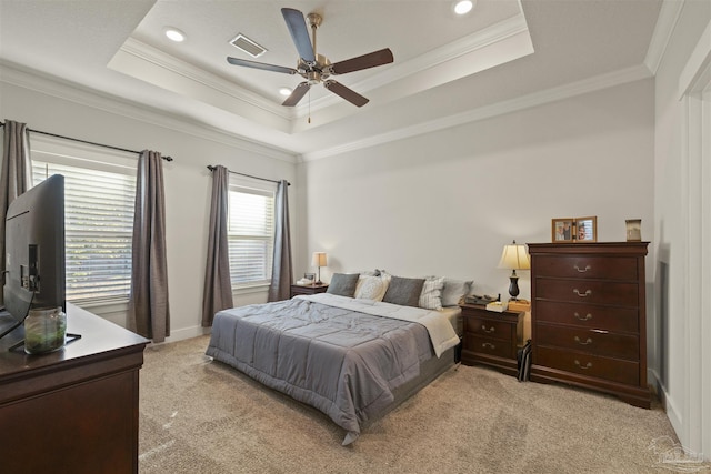 bedroom featuring a raised ceiling, light colored carpet, ceiling fan, and ornamental molding