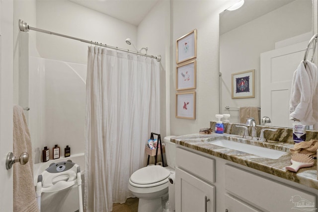 bathroom featuring toilet and vanity