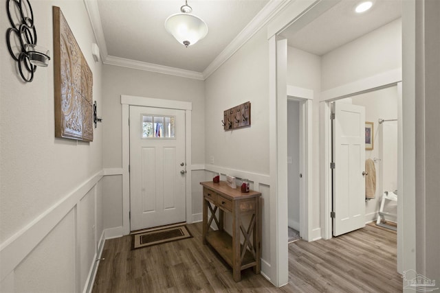 doorway to outside with crown molding and hardwood / wood-style flooring