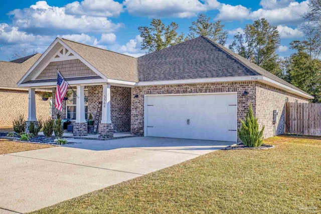 view of front facade with a garage, a front lawn, and covered porch