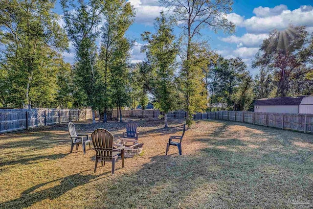 view of yard with a fire pit