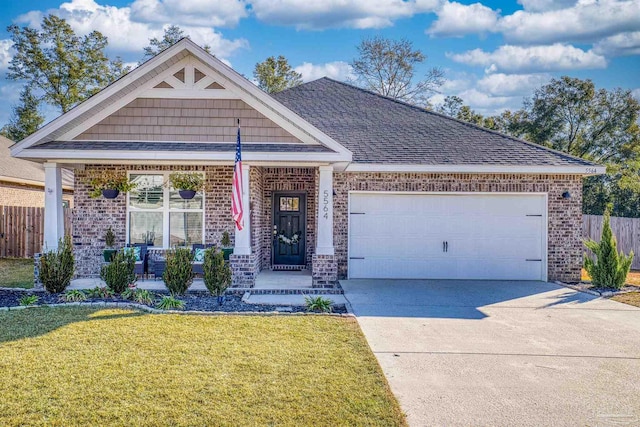 craftsman-style home featuring a garage, a front yard, and a porch