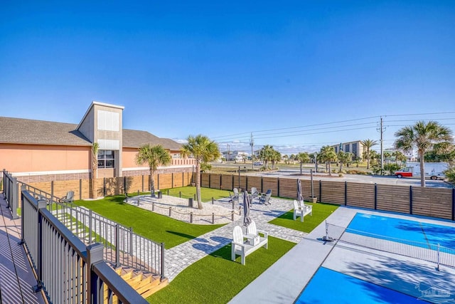 exterior space with a lawn and fence