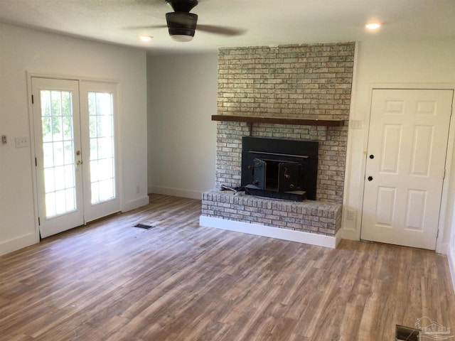 unfurnished living room with hardwood / wood-style floors, a textured ceiling, and ceiling fan