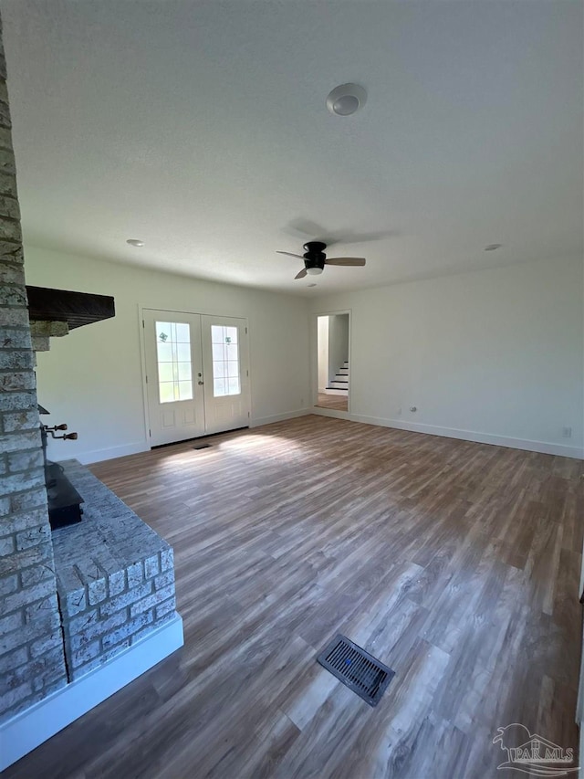 unfurnished living room with ceiling fan and hardwood / wood-style floors