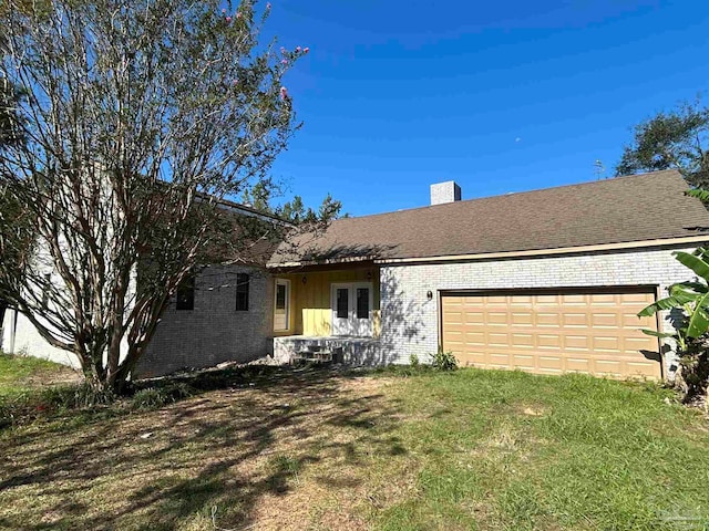 ranch-style house with a front yard and a garage