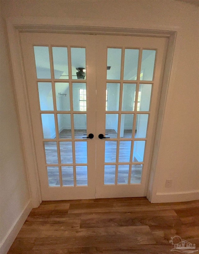 doorway with french doors and wood-type flooring