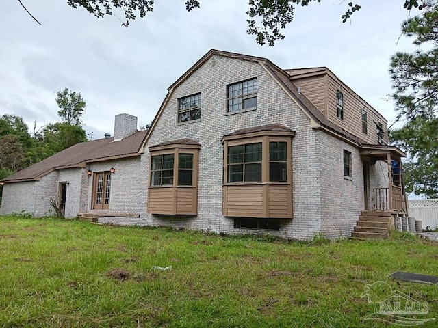 back of house featuring a yard and cooling unit