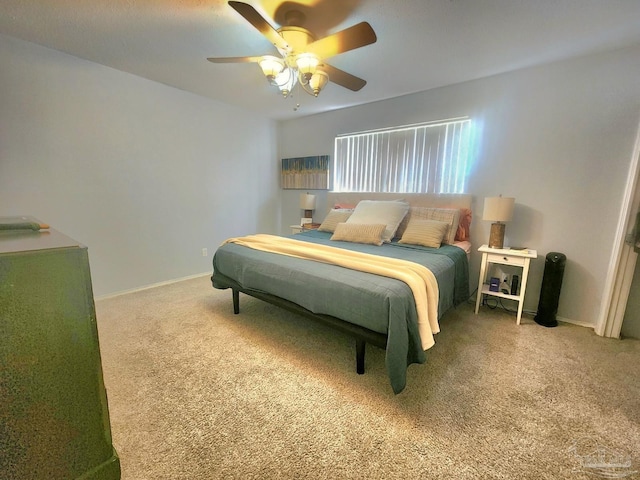 bedroom featuring ceiling fan, baseboards, and carpet floors