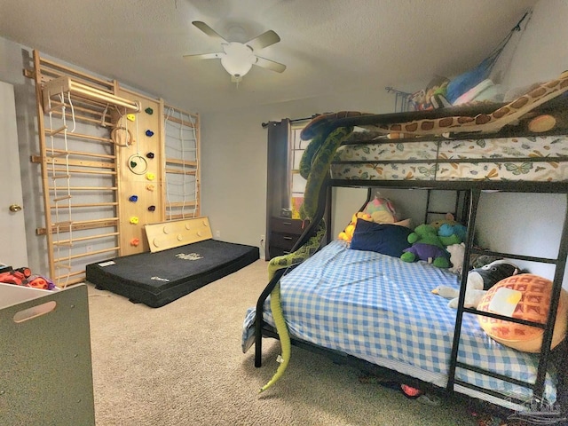 bedroom with a textured ceiling, a ceiling fan, and carpet floors
