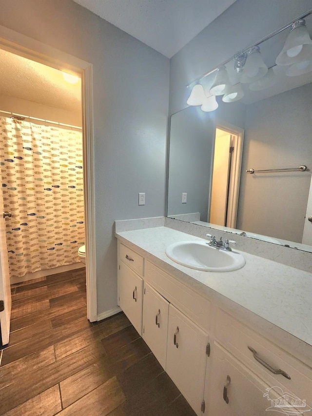 full bath with toilet, wood finished floors, vanity, and a shower with curtain