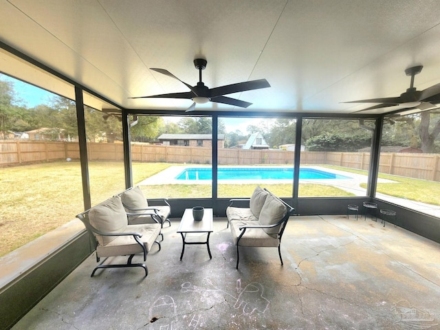 sunroom / solarium featuring ceiling fan