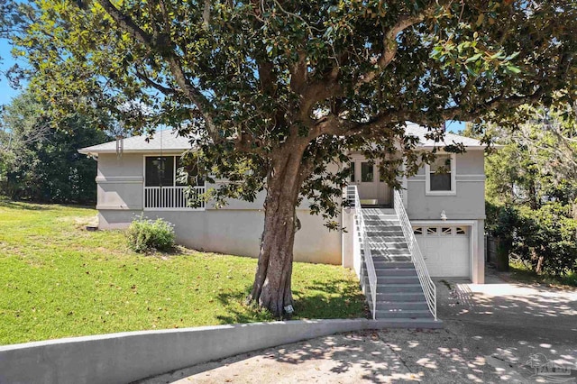 view of front of home with a garage and a front yard