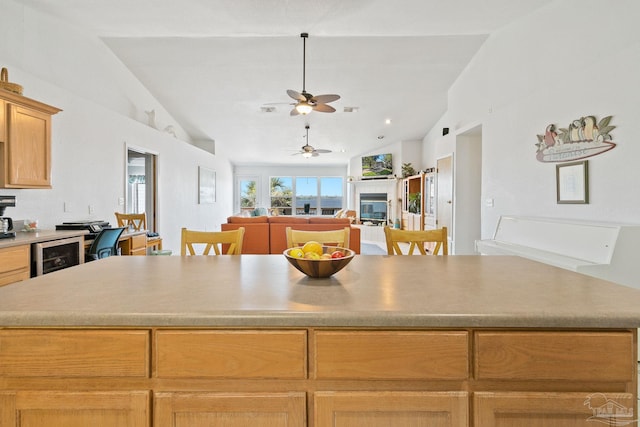 kitchen with lofted ceiling, wine cooler, and ceiling fan