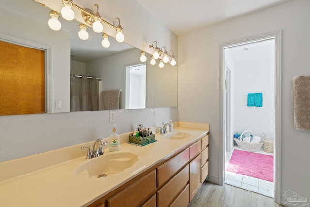 bathroom featuring dual vanity and wood-type flooring