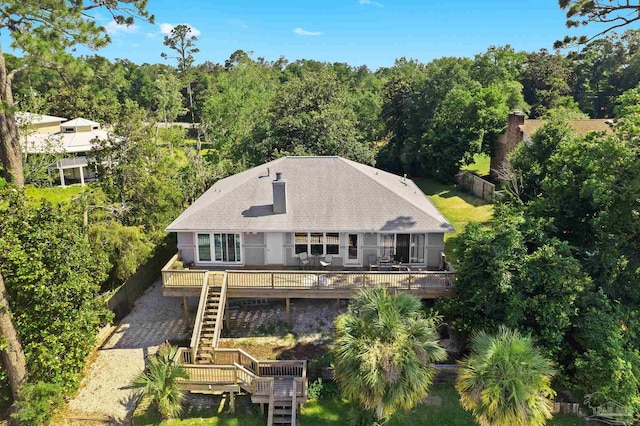 rear view of property featuring a deck