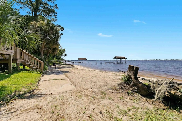 view of water feature with a dock and a beach view